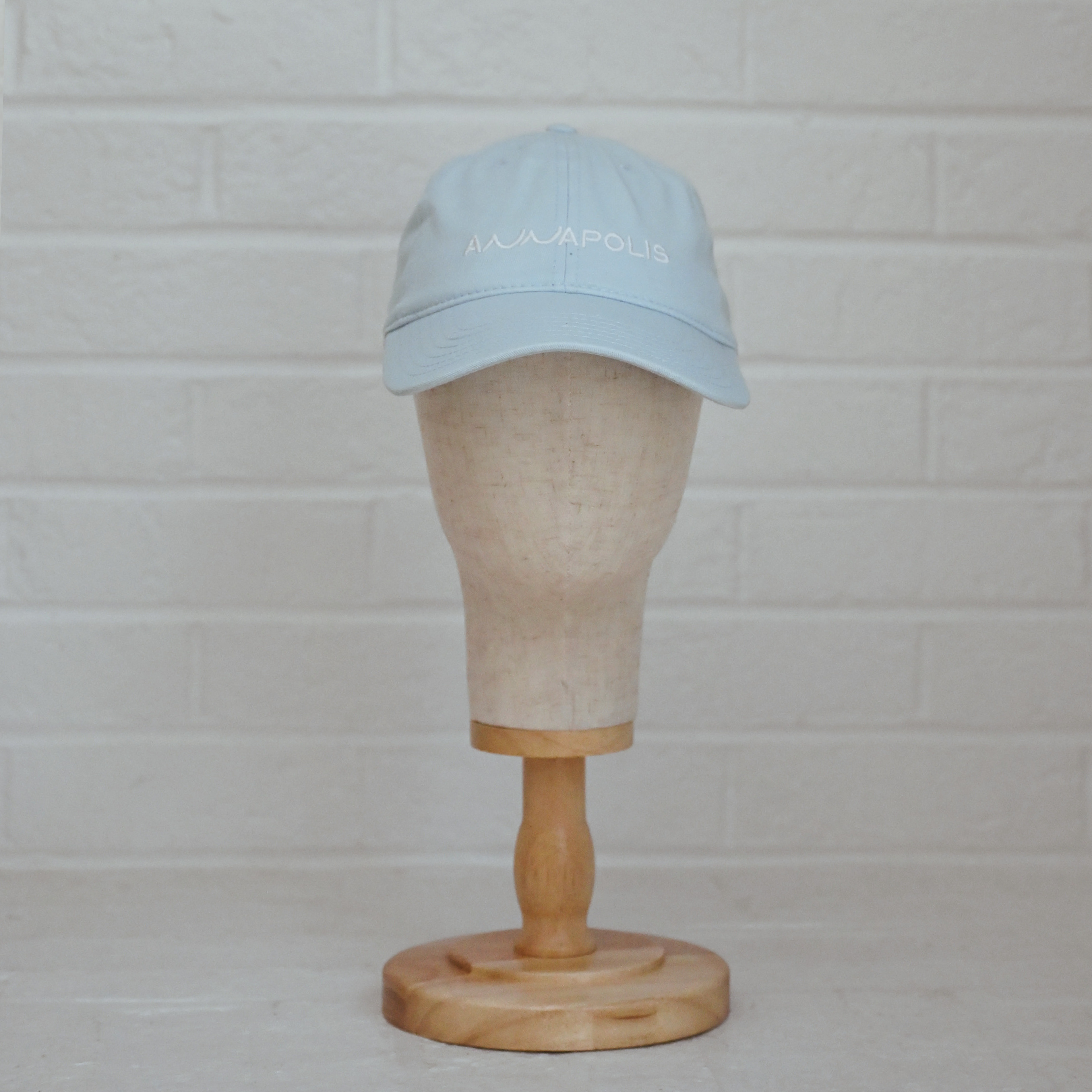Powder blue unstructured low-profile dad hat with white embroidered Annapolis script.