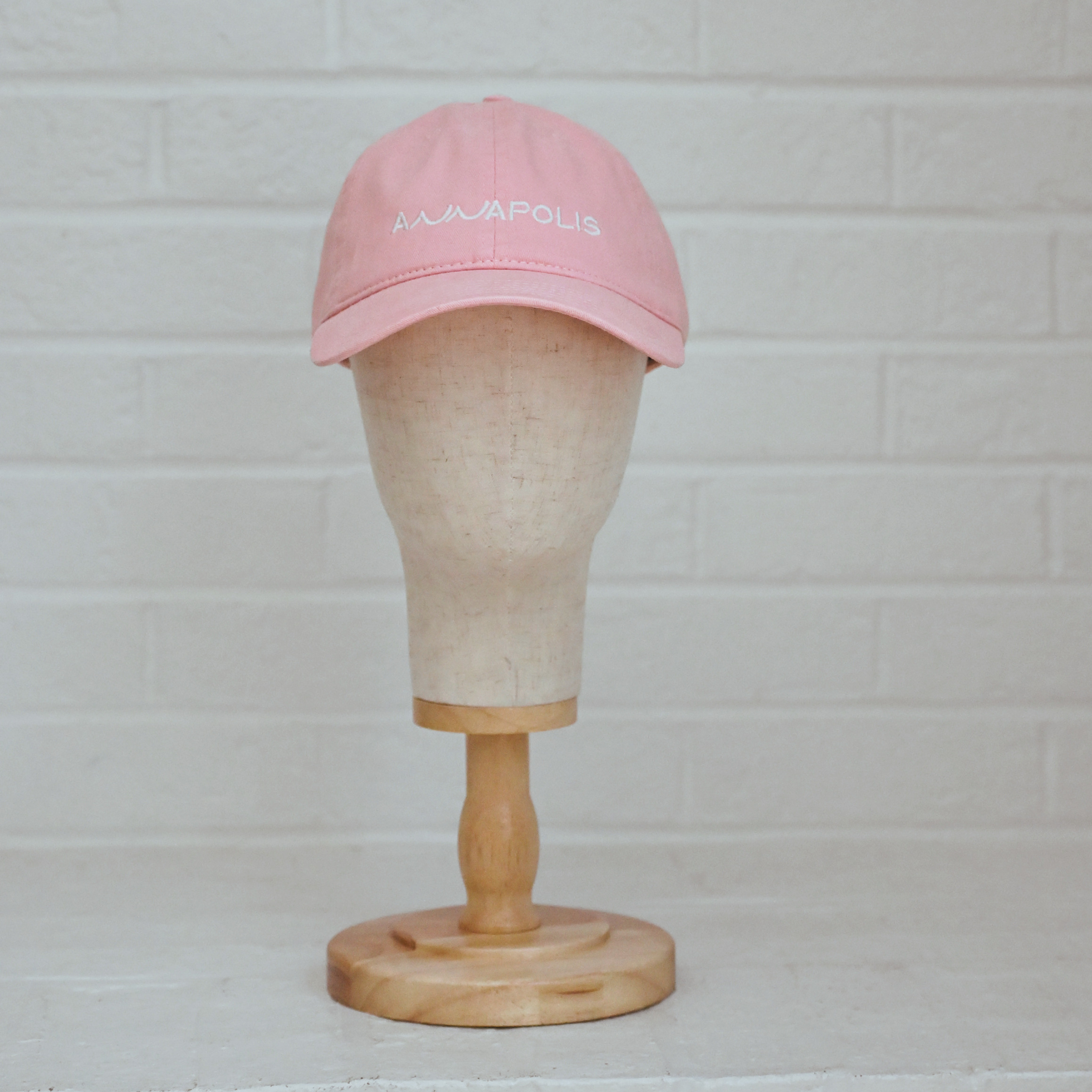 Soft pink unstructured low-profile dad hat with white embroidered Annapolis script.